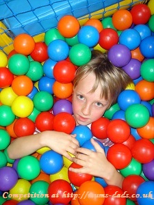 Boy playing with bright and colourfuul balls