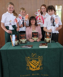 Mrs Kate Sargent and CHS students Anna Cusworth, Oliver Brown, Isabelle Ashworth and Thomas Scott, with props which illustrate the costumes worn at the time the book was set.
