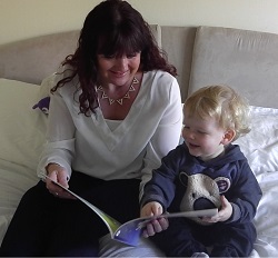 Parent and child enjoying reading book together