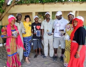 Community leaders in Illiassa accept solar lamps donated by the Withington Gambia group to help local people. (big image)