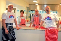 L-R Dean Jenkins, Francis House chef with volunteers Margaret Derbyshire and Derek Charleston with Simon Rimmer at the opening of the hospice’s new kitchen.