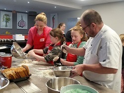 Jayne cooking with her kids at Food Sorcery Big and Little Cook Event