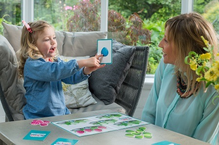 Parent and child playing one of The Curious Dragons board game