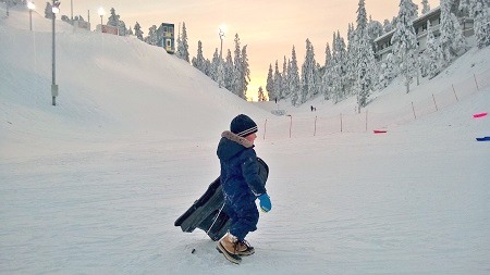 Sledging at the slope next to Ski Inn Aurinkorinne Apartments, Ruka
