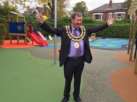 Councillor Walter Brett, Mayor of Stockport, is cutting ribbon at Hulme Hall School new outdoor classroom