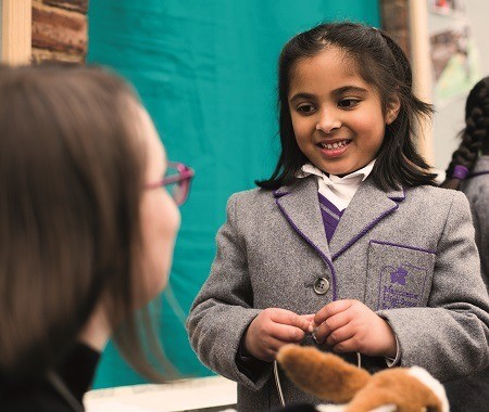 Teacher encouraging a girl to speak her mind