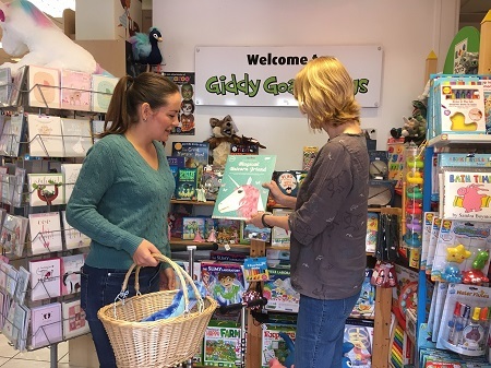 Inside the Giddy Goat Toys - shop assistant with a customer