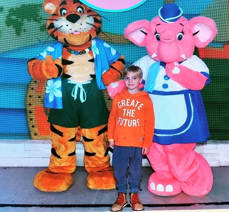 Boy with costumed elephant friend