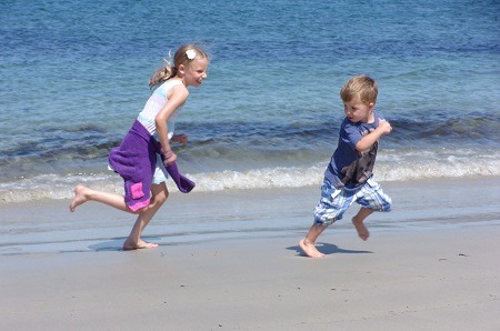 Harriett chases Henry on the beach at Guernsey