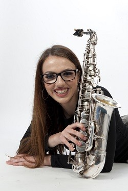 King's Alumni Alex Clarke with her saxophone