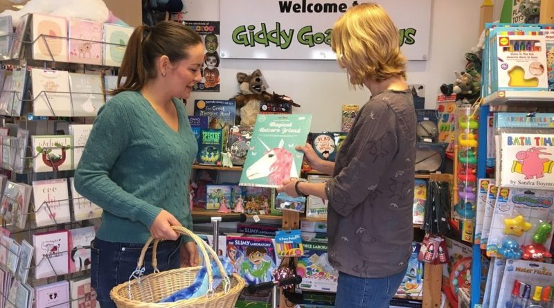 Giddy Goat Toys shop assistant is speaking with a customer