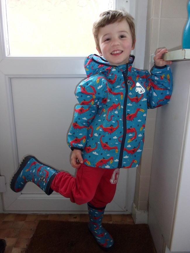Boy wearing frugi coat and boots