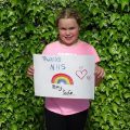 Girl holds Thank you NHS rainbow