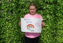 Girl holds Thank you NHS rainbow