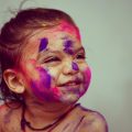 Little girl having fun at the Festival of Colours | photo: Pranav Kumar Jain, unsplash
