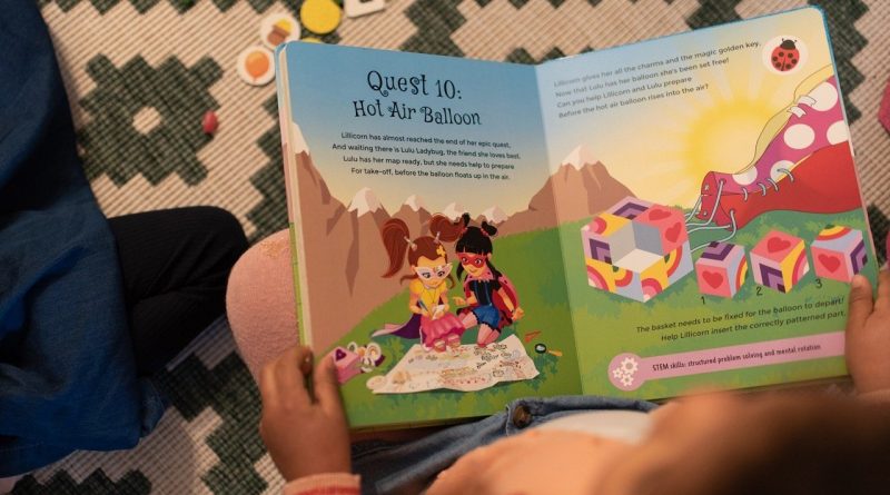 A child reading The Adventures of Lillicorn in WooWoo Land
