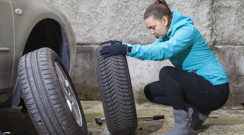 Female changing tyre