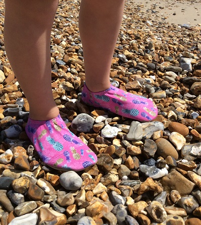 On a stony beach in a LookLikeCool's fabric heat-protective slip resistant shoes