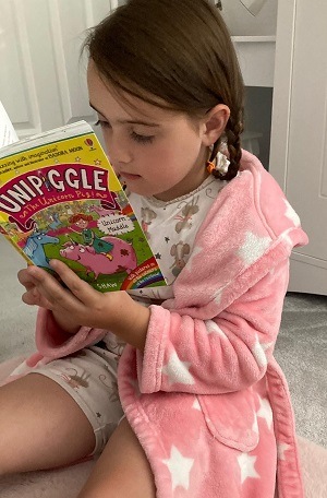 A girl reading Usborne's book