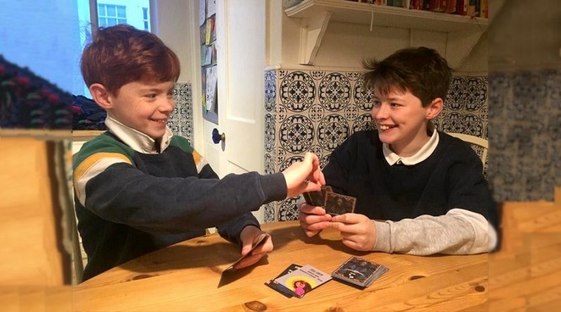 Boys playing Fame or Forfeit card game
