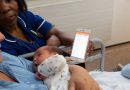 New mum is shown Mum & Baby app by a midwife