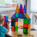 Girl playing with Magna-Tiles building blocks
