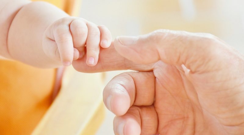 Mother & Baby holds fingers- baby skin feelings