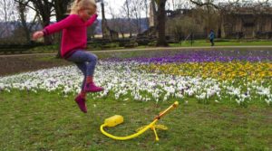 Girl launching Stomp Rocket stunt plane