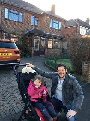 Dad with kid outside new home