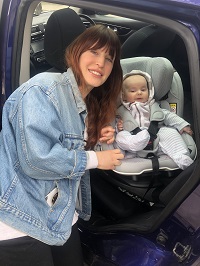 Mum with a baby in a car seat
