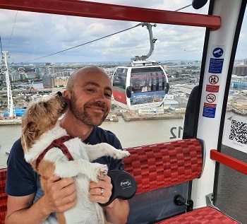 man with a dog on Emirates skyline