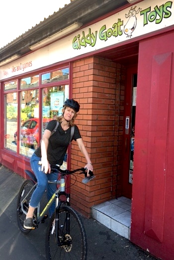 Amanda Alexander on her bicycle near Giddy Goar Toy shop, after doing round to raise money for the Toy Trust