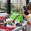 Girl playing with The Railway Bucket Builder set