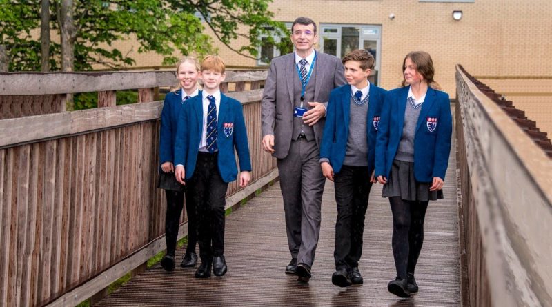 Jason Slack, Head of Foundation at The King's School in Macclesfield, with pupils on the school's bridge