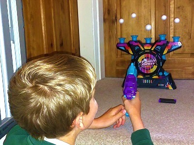 Boy playing with Electronic Arcade Hover Shot