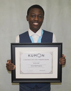 Boy holding Kumon certificate