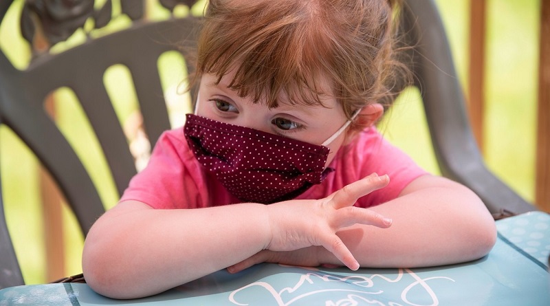 Girl wearing face mask, photo by Rusty Watson