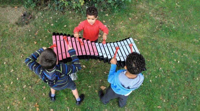 Kids with giant metal xylophone in the park