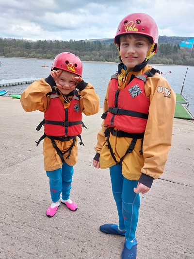 Kids wearing wetsuits, waterproof jackets