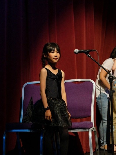 Girl singing on scene