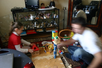 Father and daughter playing building game