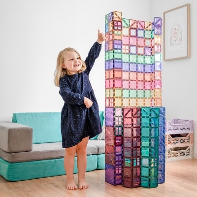Girl builds tower with Connetix Pastel Magnetic Tiles