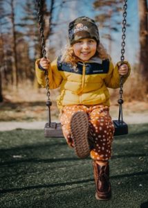 Girl on swings by janko ferlic -unsplash