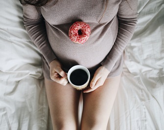 Pregnant woman with coffee | Photo by Fallon Michael, Unsplash