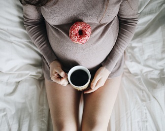 Pregnant woman with coffee