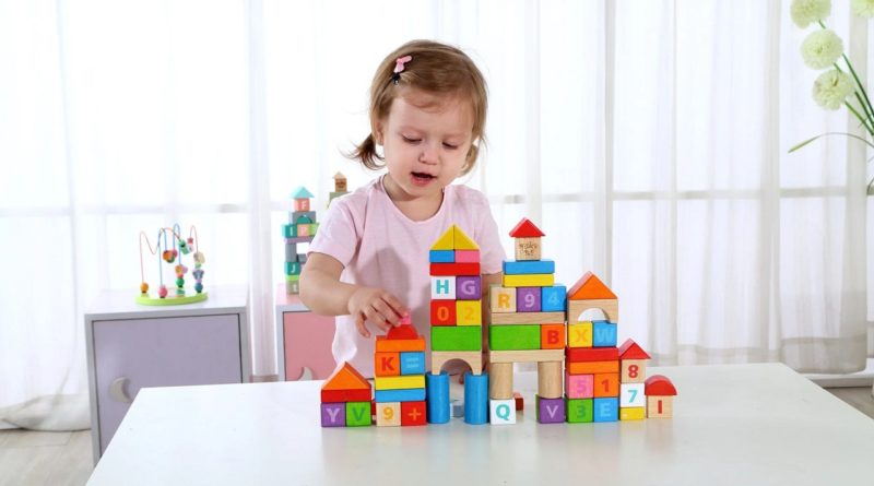 Girl playing with Tooky 70pcs rubber wood blocks set