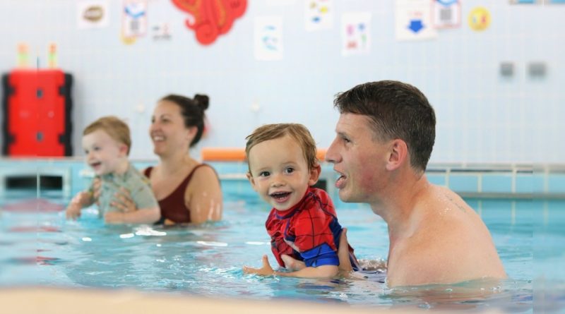 Families in the swimming pool at the Water Babies Splashathon event