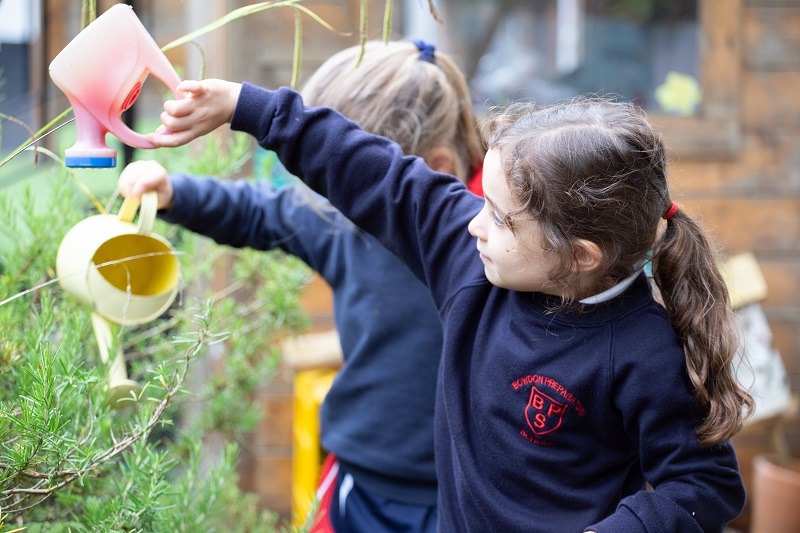 Bowdon Preparatory pupils watering rosemary