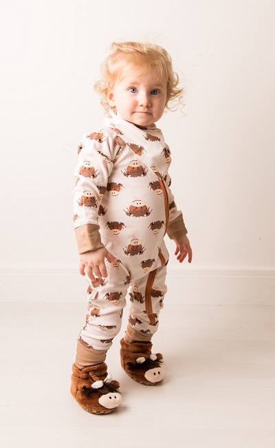 Child wearing onesie, bib and booties from Hamish Highland Cow Neutral Collection by Blade and Rose