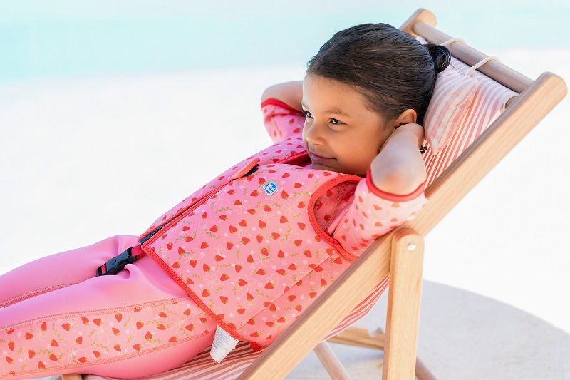 Girl wearing Go Splash Swim West and UV Sun Sea Wetsuit with strawberry field design